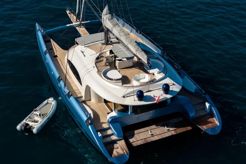 Lyfe At Sea Yacht Photos Pics Luxurious 2015 Magic Yachts Custom catamaran on open water, with tender boat alongside.