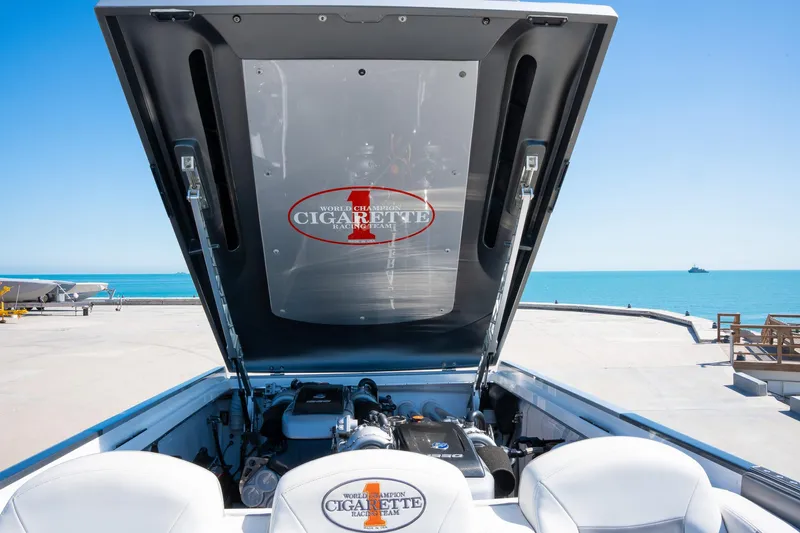  Yacht Photos Pics 2017 Cigarette 50 Marauder engine compartment with open hatch, docked by the sea.