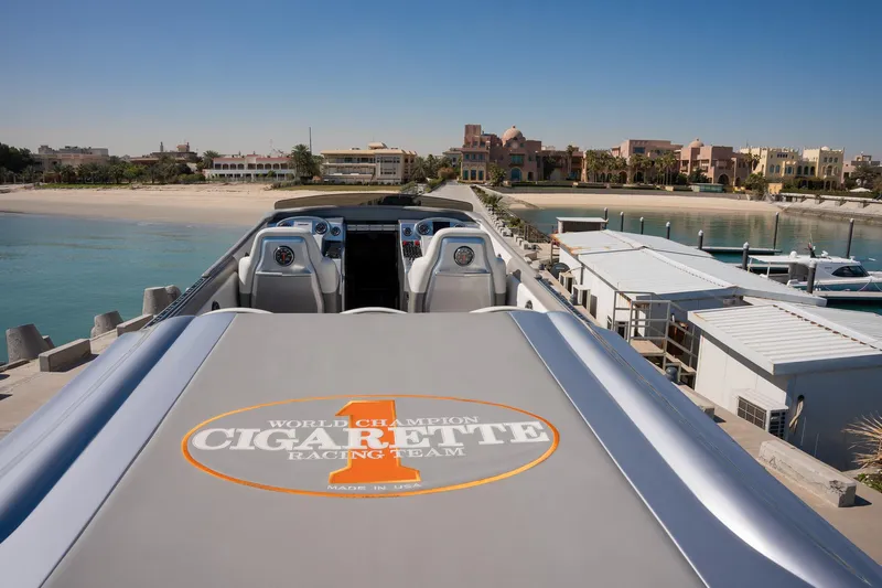  Yacht Photos Pics 2017 Cigarette 50 Marauder speedboat docked near a beach.