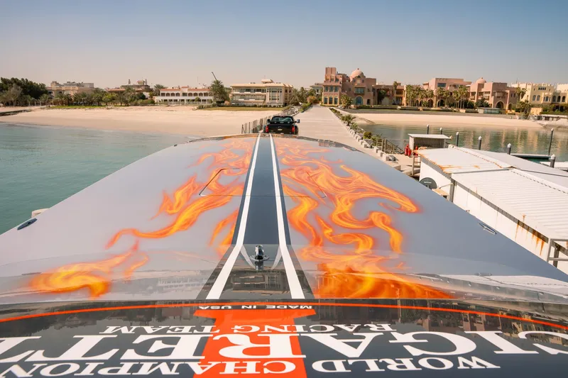  Yacht Photos Pics 2017 Cigarette 50 Marauder speedboat with flame decals docked at a luxurious waterfront.