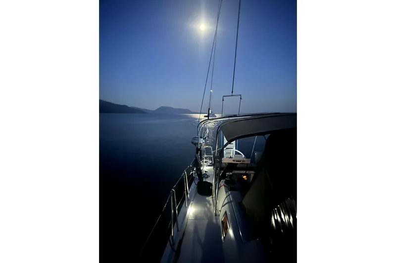  Yacht Photos Pics Sailing at night on a 2024 Dufour 530 yacht under a bright moonlit sky.