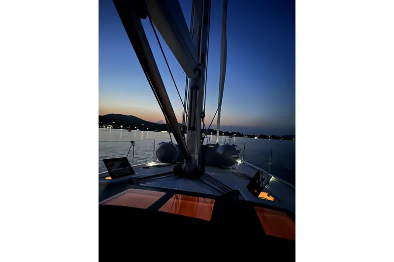  Yacht Photos Pics Dufour 530 sailboat at sunset, 2024 model, serene waterscape view.