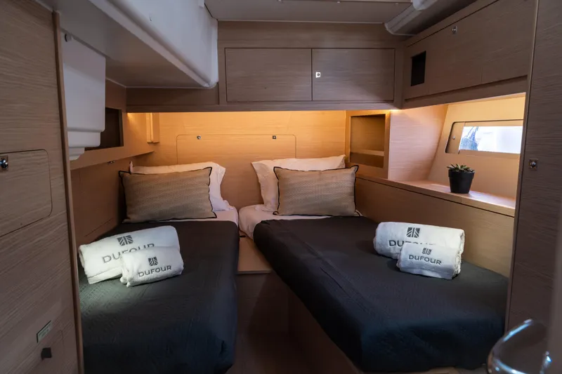  Yacht Photos Pics Luxurious cabin interior of 2024 Dufour 530 yacht with twin beds and elegant decor.