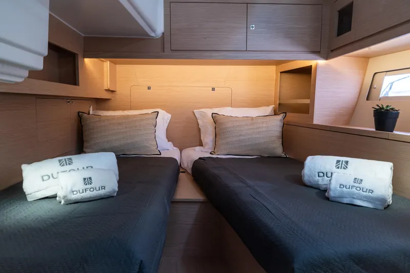  Yacht Photos Pics Luxurious cabin interior of 2024 Dufour 530 yacht with twin beds and elegant decor.