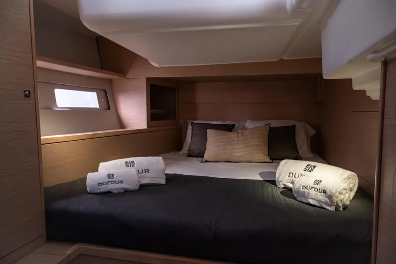  Yacht Photos Pics Luxurious cabin interior of 2024 Dufour 530 yacht with cozy bedding and towels.