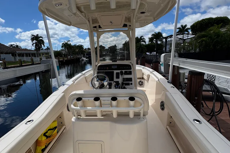  Yacht Photos Pics 2024 Grady-White Fisherman 236 boat interior with steering console, docked by a canal.