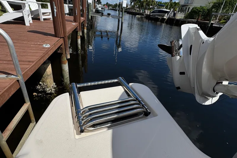  Yacht Photos Pics 2024 Grady-White Fisherman 236 boat ladder and motor by a dock.