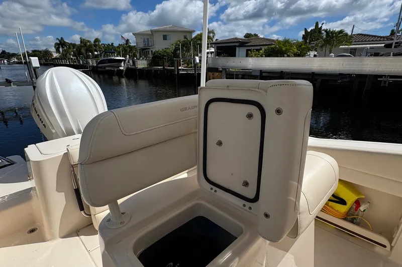  Yacht Photos Pics 2024 Grady-White Fisherman 236 boat interior with seating and storage, docked by waterfront homes.