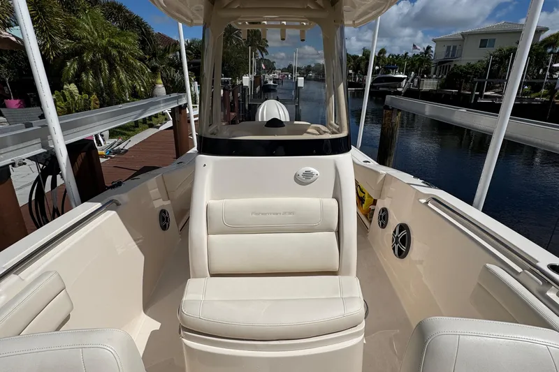  Yacht Photos Pics 2024 Grady-White Fisherman 236 boat interior with seating, docked by a canal.