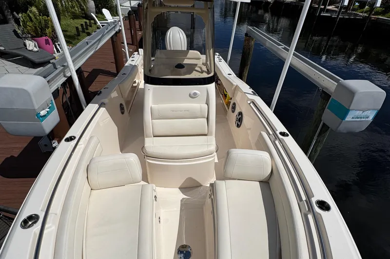  Yacht Photos Pics 2024 Grady-White Fisherman 236 boat interior with white seating, docked by the water.
