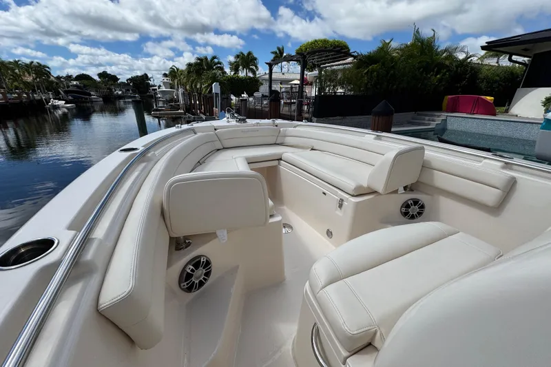  Yacht Photos Pics 2024 Grady-White Fisherman 236 boat interior with white seating and waterfront view.
