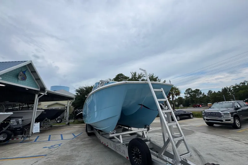  Yacht Photos Pics 2025 Invincible 40 Catamaran on trailer, parked outdoors under cloudy sky.
