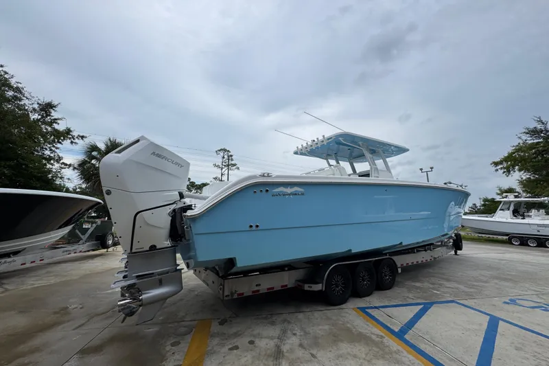  Yacht Photos Pics 2025 Invincible 40 Catamaran in light blue on a trailer, featuring Mercury outboard engines.