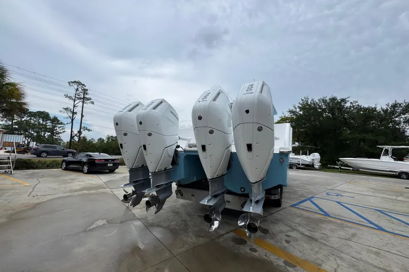  Yacht Photos Pics 2025 Invincible 40 Catamaran with triple outboard engines in a parking lot.