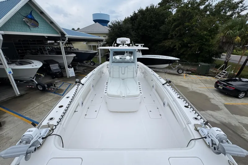  Yacht Photos Pics 2025 Invincible 40 Catamaran docked at a marina, showcasing spacious deck and modern design.