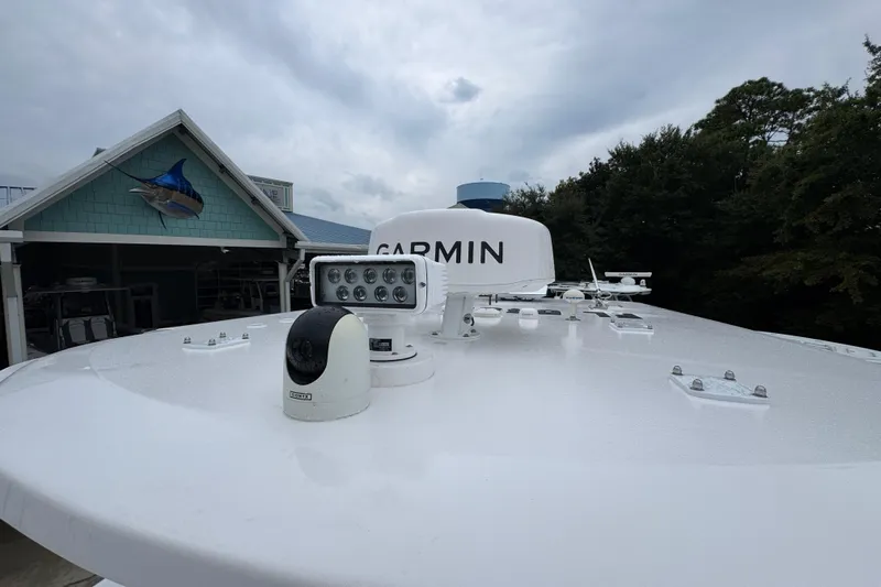 Yacht Photos Pics Rooftop of 2025 Invincible 40 Catamaran with Garmin equipment, near a building with fish decor.