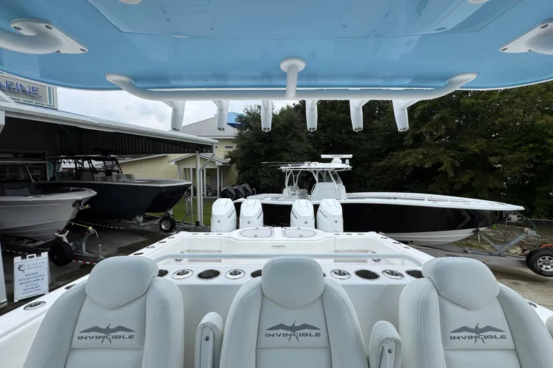  Yacht Photos Pics 2025 Invincible 40 Catamaran with sleek design, docked at a marina.