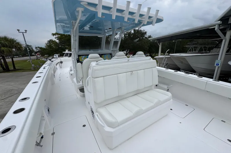  Yacht Photos Pics 2025 Invincible 40 Catamaran with white seating and spacious deck, docked outdoors.