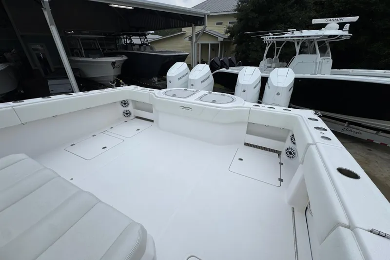  Yacht Photos Pics 2025 Invincible 40 Catamaran boat deck with multiple outboard engines in a marina setting.