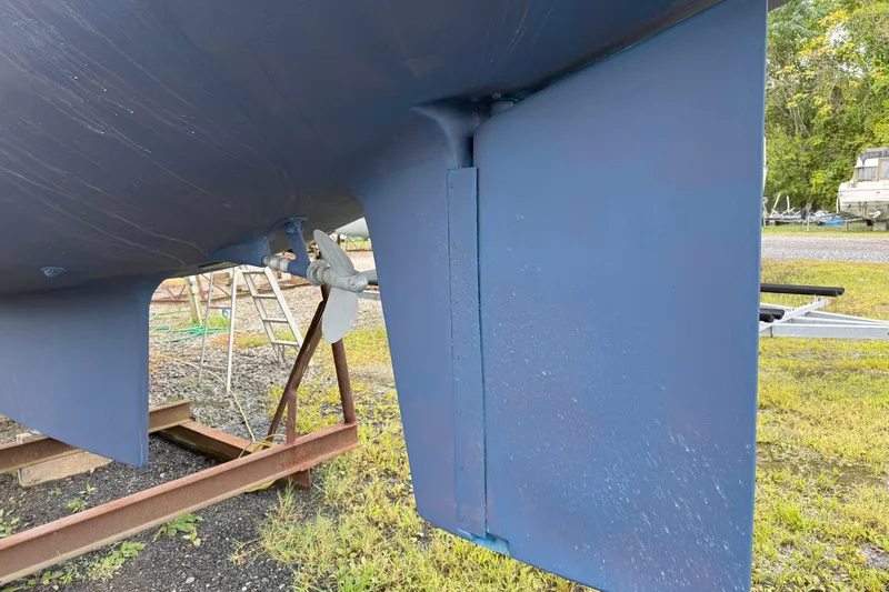 Mer Du Jour Yacht Photos Pics Close-up of 2005 Caliber 40 LRC SE sailboat hull and rudder on a stand.