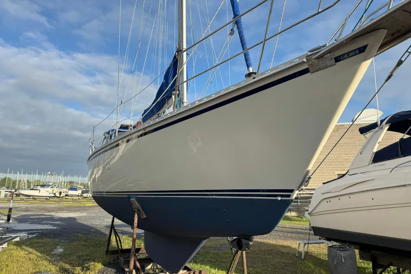 Mer Du Jour Yacht Photos Pics 2005 Caliber 40 LRC SE sailboat on land, blue and white hull, clear sky background.