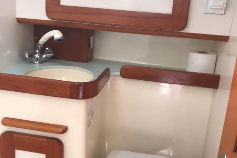 Mer Du Jour Yacht Photos Pics 2005 Caliber 40 LRC SE yacht bathroom with wooden accents and sink.