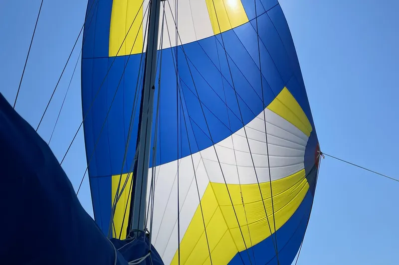 Mer Du Jour Yacht Photos Pics Colorful sail of 2005 Caliber 40 LRC SE against clear blue sky.