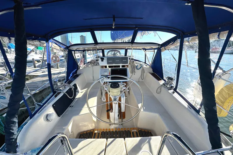 Mer Du Jour Yacht Photos Pics Cockpit of 2005 Caliber 40 LRC SE sailboat with steering wheel and navigation equipment.