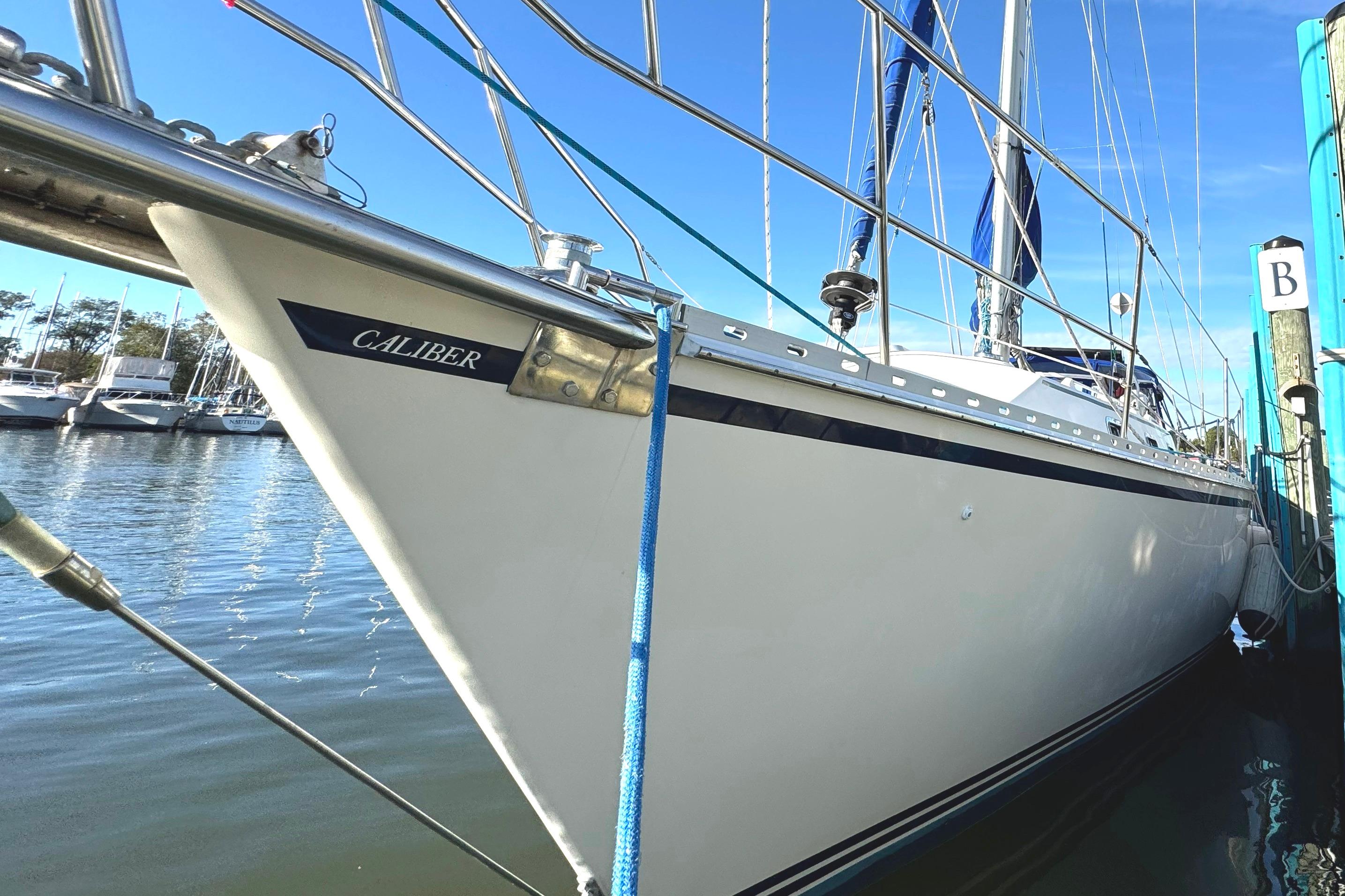 2005 Caliber 40 LRC SE sailboat docked in marina, clear blue sky.