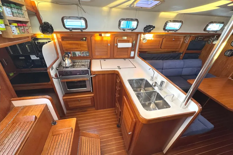 Mer Du Jour Yacht Photos Pics Luxurious 2005 Caliber 40 LRC SE yacht interior with modern kitchen and seating area.
