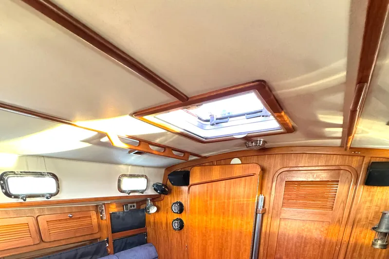 Mer Du Jour Yacht Photos Pics Interior of 2005 Caliber 40 LRC SE sailboat with wooden paneling and skylight.