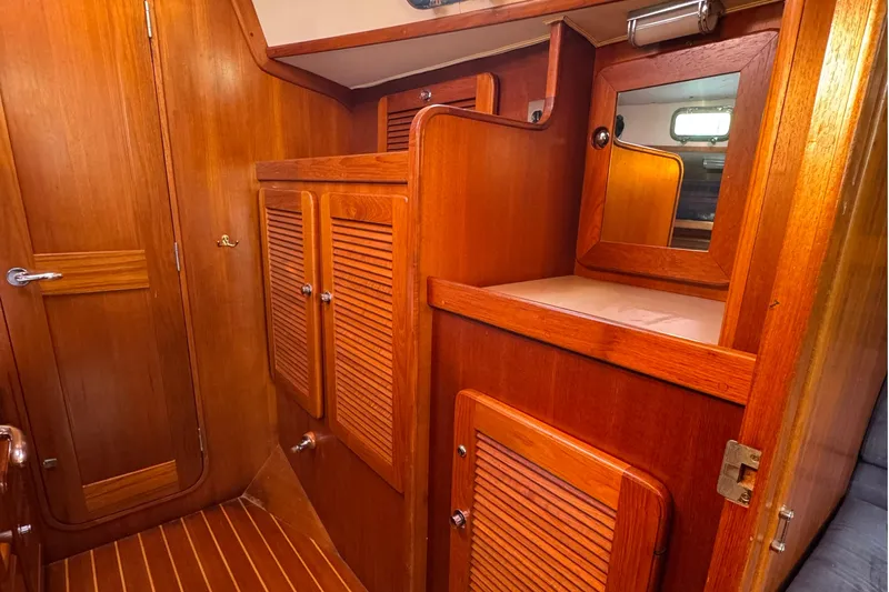 Mer Du Jour Yacht Photos Pics Interior of 2005 Caliber 40 LRC SE yacht with wooden cabinetry and mirror.