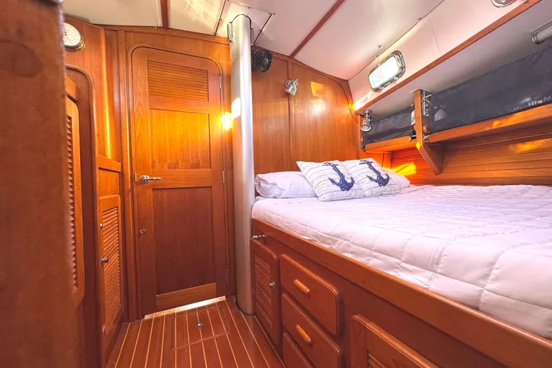 Mer Du Jour Yacht Photos Pics Cozy cabin interior of 2005 Caliber 40 LRC SE yacht with wooden finish and nautical decor.