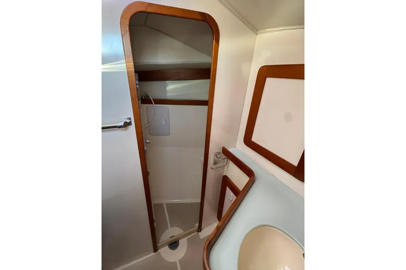 Mer Du Jour Yacht Photos Pics Bathroom interior of 2005 Caliber 40 LRC SE yacht with wooden accents.