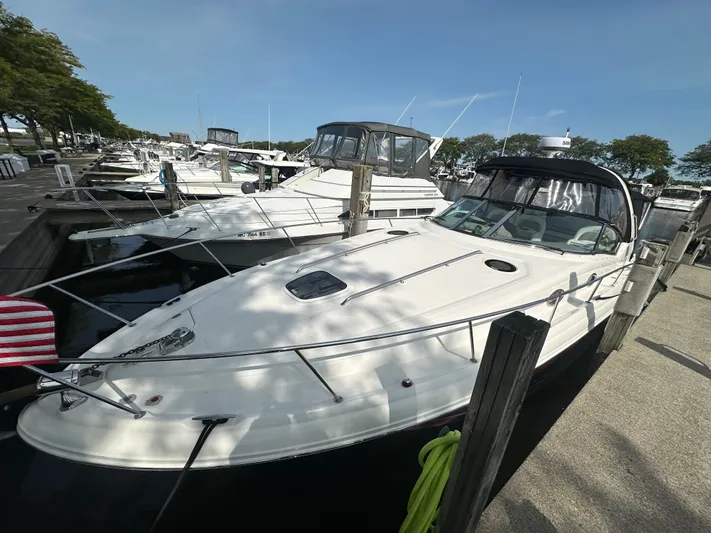  Yacht Photos Pics 2007 Sea Ray 340 Sundancer docked at marina, surrounded by other boats, under clear blue sky.