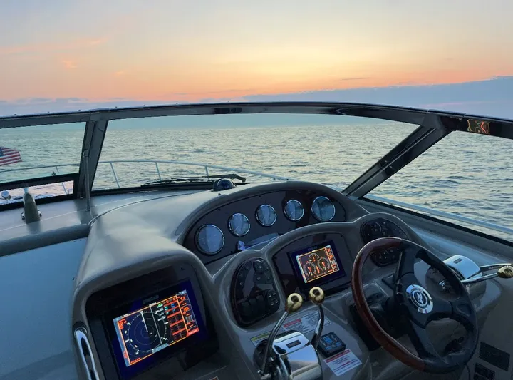  Yacht Photos Pics 2007 Sea Ray 340 Sundancer helm with sunset view over the ocean.