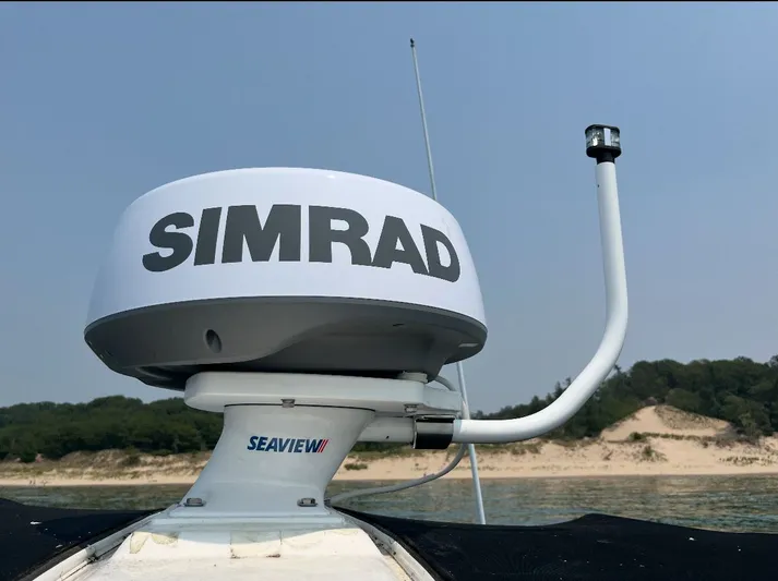  Yacht Photos Pics Simrad radar on 2007 Sea Ray 340 Sundancer, with beach and trees in background.