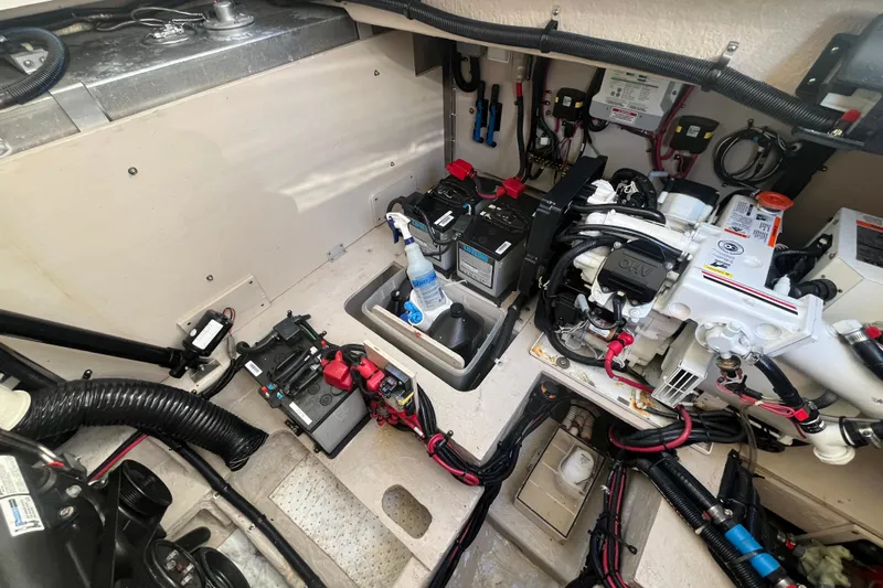 Just Plane Fun Yacht Photos Pics Engine compartment of a 2014 Sea Ray 350 Sundancer, showcasing batteries and mechanical components.