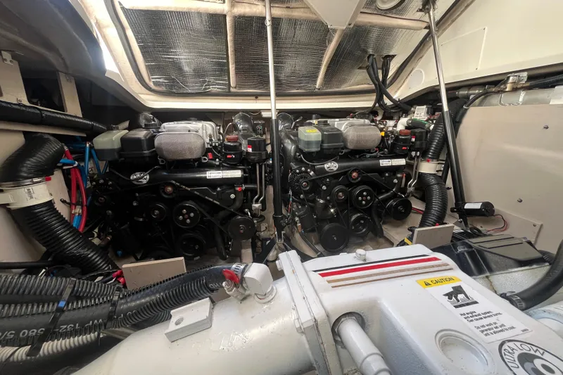 Just Plane Fun Yacht Photos Pics Engine room of a 2014 Sea Ray 350 Sundancer, showcasing dual engines and mechanical components.