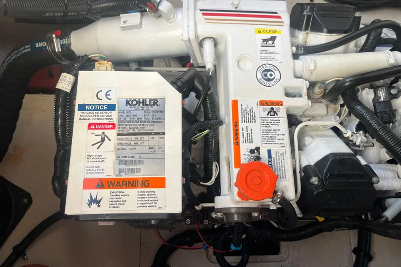 Just Plane Fun Yacht Photos Pics Engine compartment of a 2014 Sea Ray 350 Sundancer with Kohler generator and safety warnings.