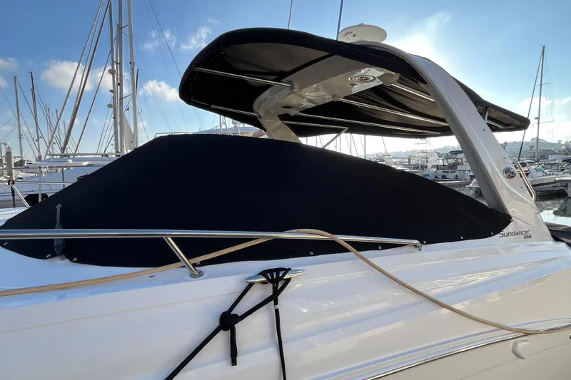 Just Plane Fun Yacht Photos Pics 2014 Sea Ray 350 Sundancer yacht docked at marina, covered and secured with ropes.
