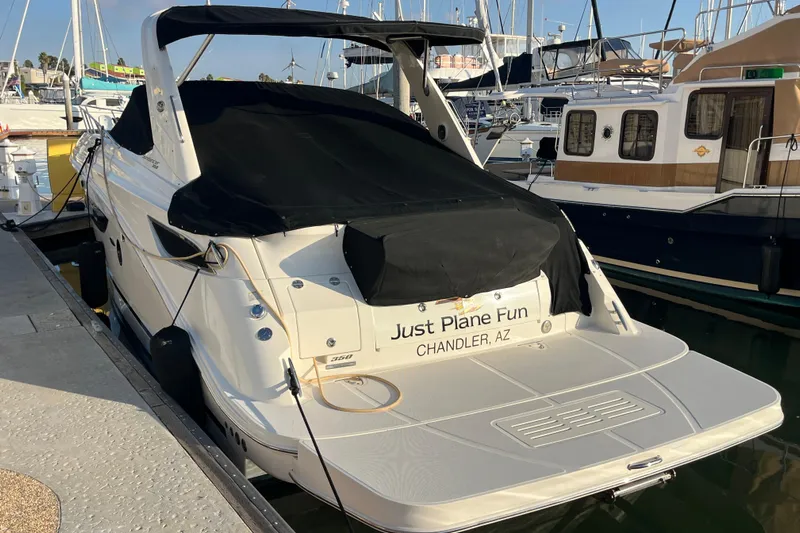 Just Plane Fun Yacht Photos Pics 2014 Sea Ray 350 Sundancer docked, covered, with "Just Plane Fun" name visible.