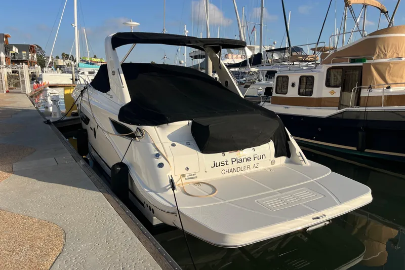 Just Plane Fun Yacht Photos Pics 2014 Sea Ray 350 Sundancer docked at marina, covered, with "Just Plane Fun" name.