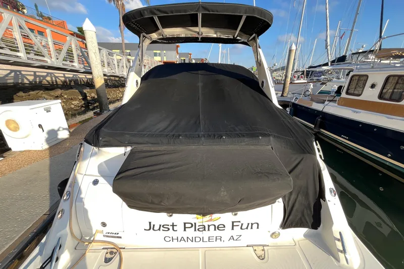 Just Plane Fun Yacht Photos Pics 2014 Sea Ray 350 Sundancer docked, covered, with "Just Plane Fun" text on the stern.