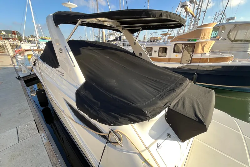 Just Plane Fun Yacht Photos Pics 2014 Sea Ray 350 Sundancer docked, covered with black canvas, in a marina setting.