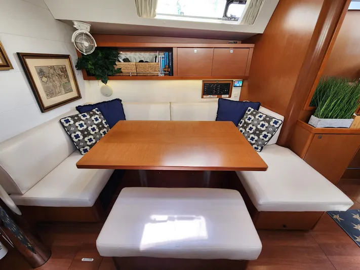 Day One Yacht Photos Pics Interior of 2016 Beneteau Oceanis 45 yacht with cozy dining area and cushions.