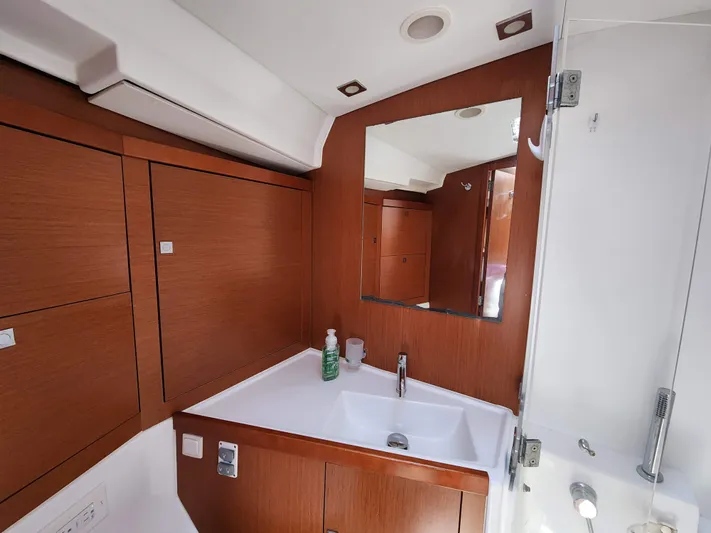 Day One Yacht Photos Pics Beneteau Oceanis 45 bathroom, 2016 model, featuring wood cabinetry and modern sink.