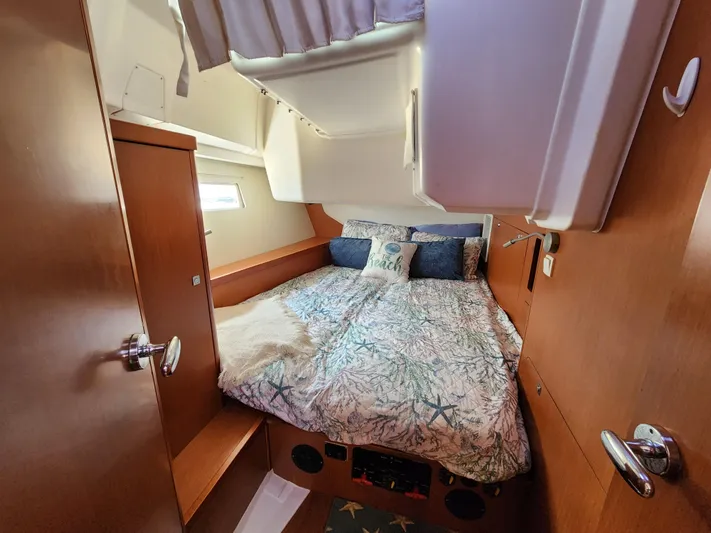 Day One Yacht Photos Pics Cozy cabin interior of 2016 Beneteau Oceanis 45 sailboat with double bed and wooden finish.