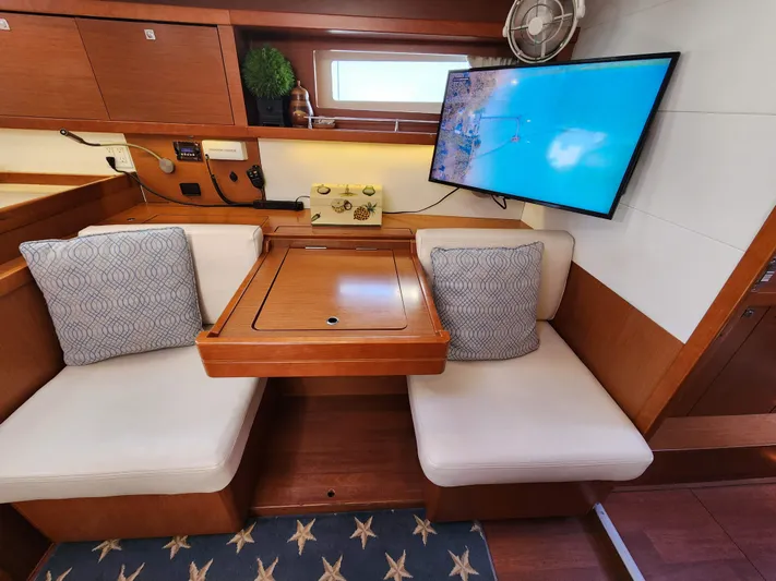 Day One Yacht Photos Pics Interior of 2016 Beneteau Oceanis 45 yacht with cozy seating and mounted TV.