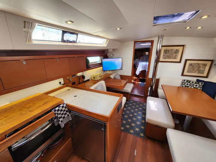 Day One Yacht Photos Pics Interior of 2016 Beneteau Oceanis 45 yacht with modern kitchen and dining area.